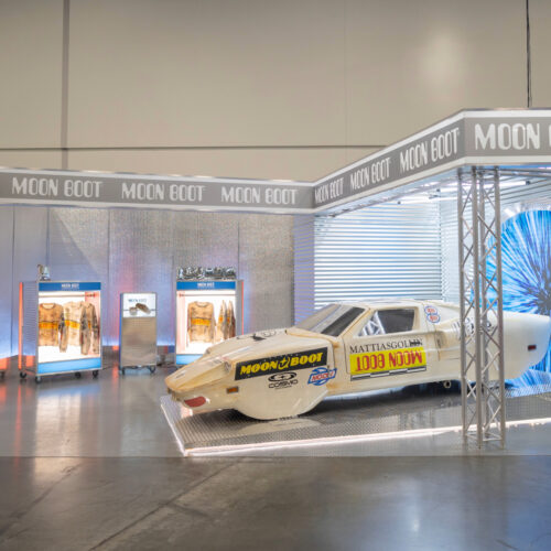 Moon Boot exhibition booth in Las Vegas featuring a custom race car display built by Coffee House Industries