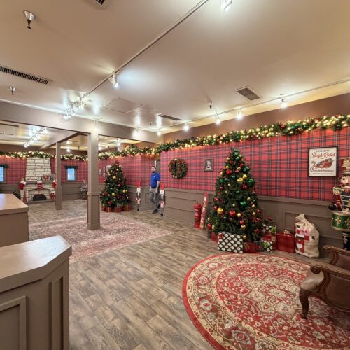 Santa’s Workshop attraction with plaid walls, Christmas trees, and holiday décor built by Coffee House Industries at Six Flags.