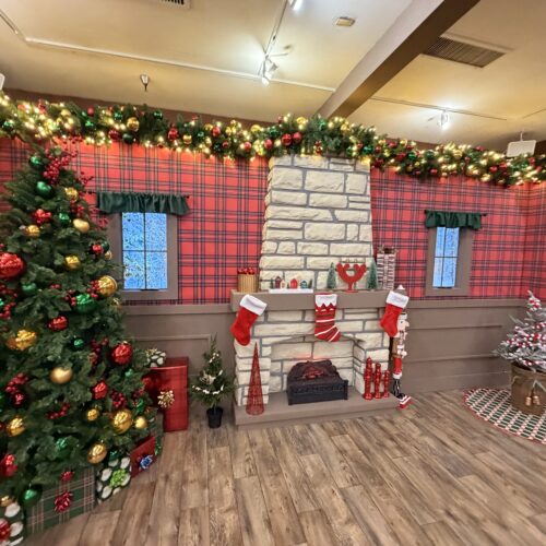 Faux winter window created by Coffee House featuring digital screens playing falling snow.